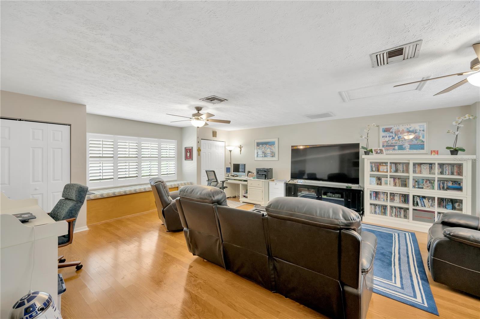 Upstairs, the massive bonus room is 20' x 28' and offers incredible flexibility with four corner closets, two large window seats, two ceiling fans, and beautiful wood floors.