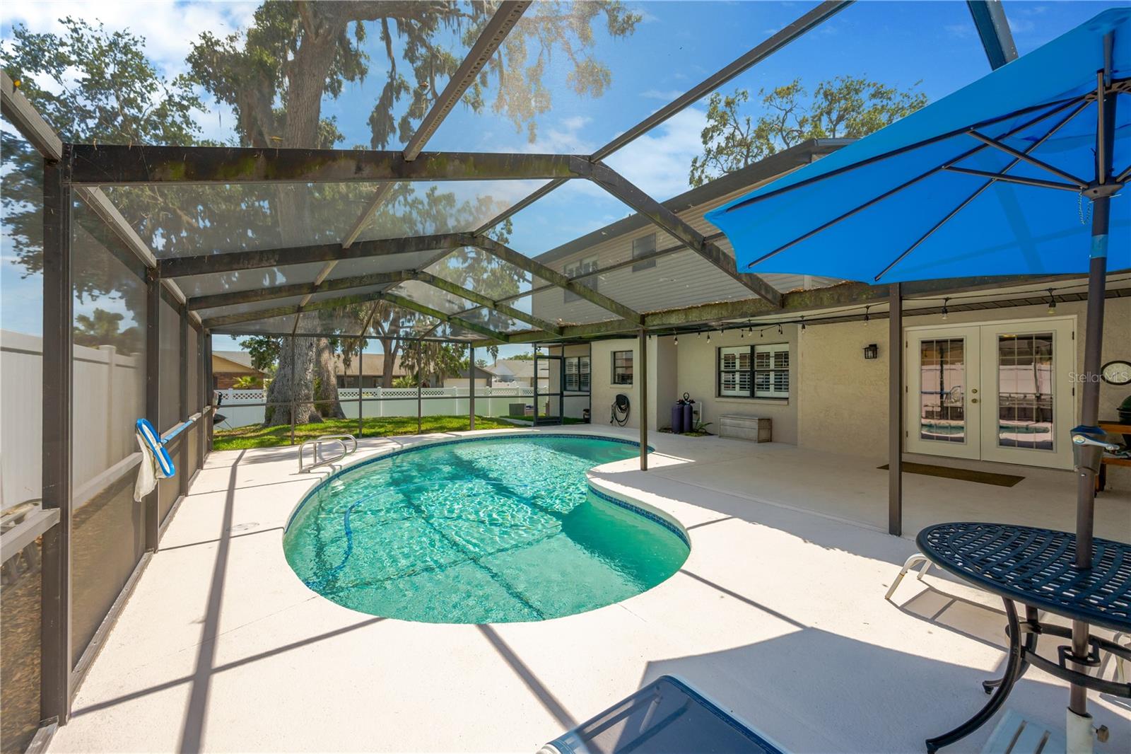Outside, enjoy Florida living at its finest in the oversized screened and covered lanai or take a dip in the inviting pool.
