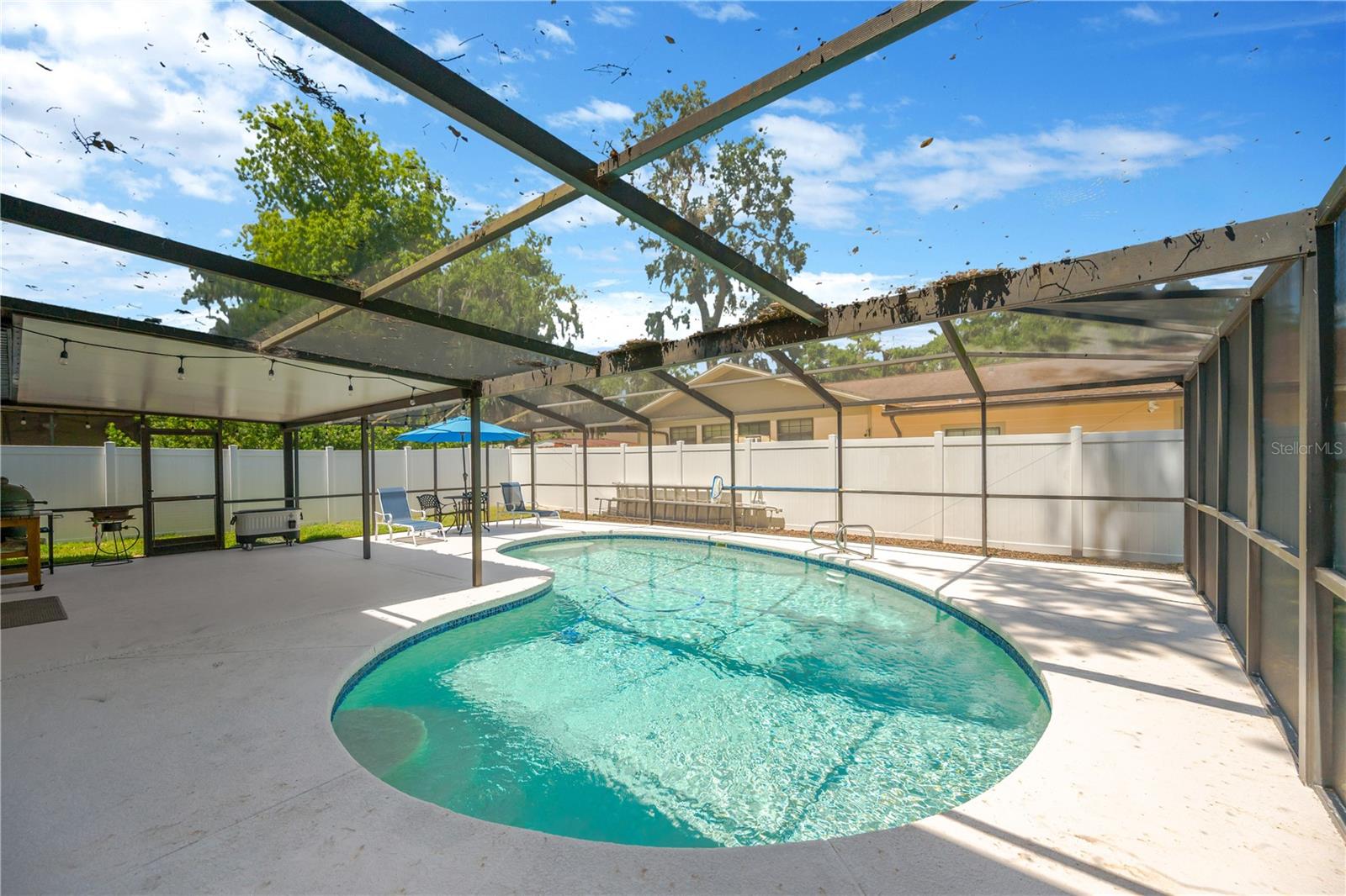The lanai features a partially covered area, providing shade and comfort for outdoor entertaining in any weather.