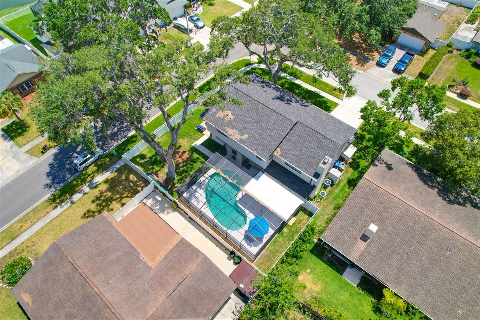 Aerial view of backyard.  There are 2 storage sheds on the side of this home by the driveway that will convey to the buyer.  There are 2 gate entrances into the fenced back yard on either side of the home.