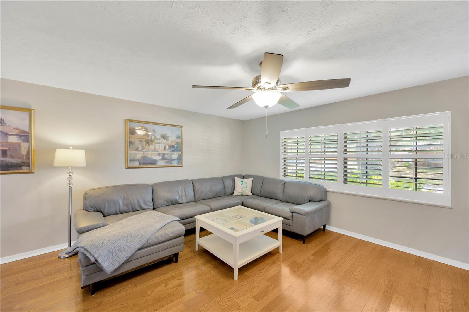 Wood floors and Plantation Shutters set the tone of quality finishes throughout this home.