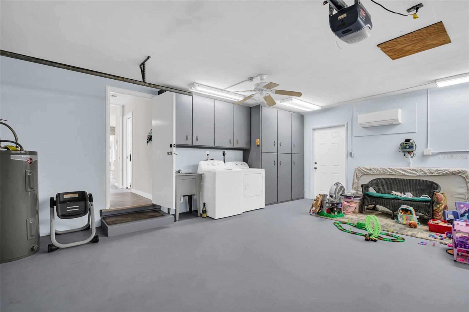 Large Garage with Cabinetry and Laundry