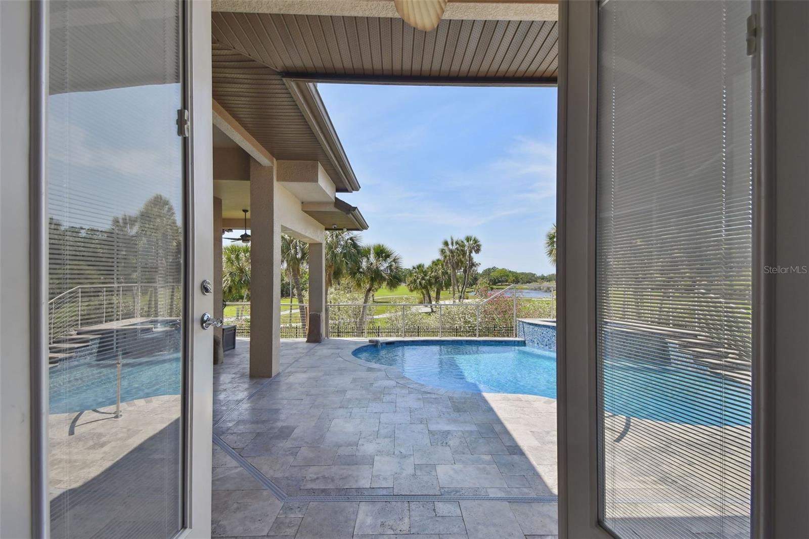 French doors opening to the pool area with golf course views.