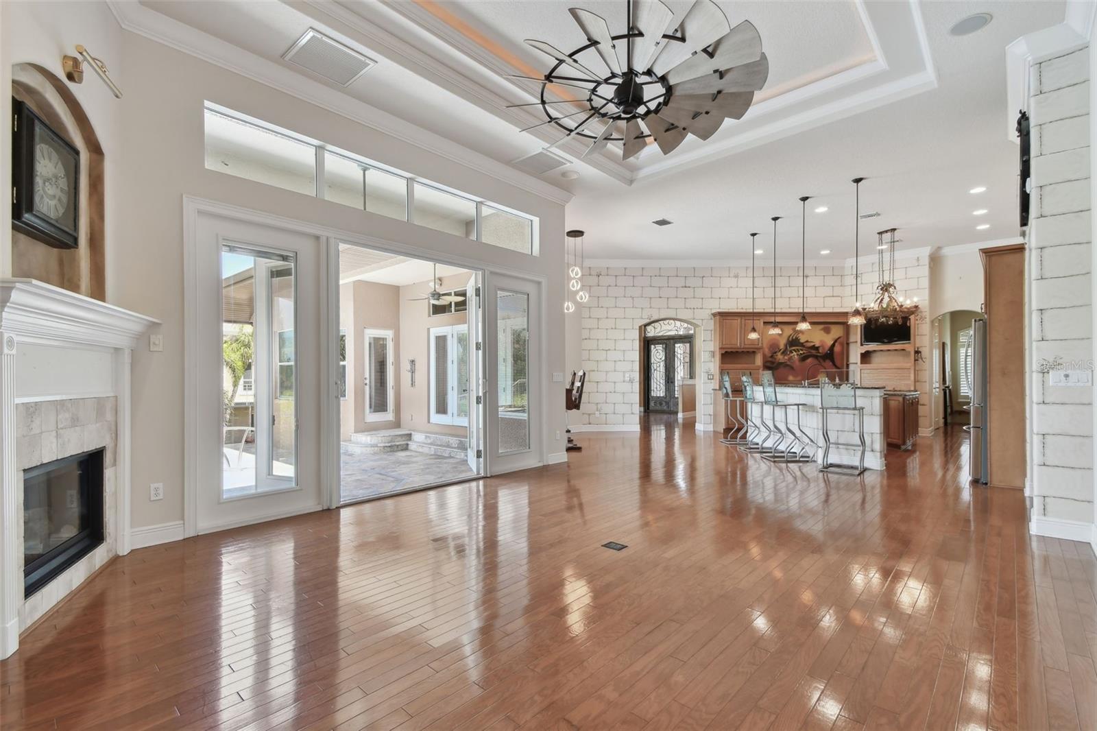Family Room with fireplace and French doors to pool area