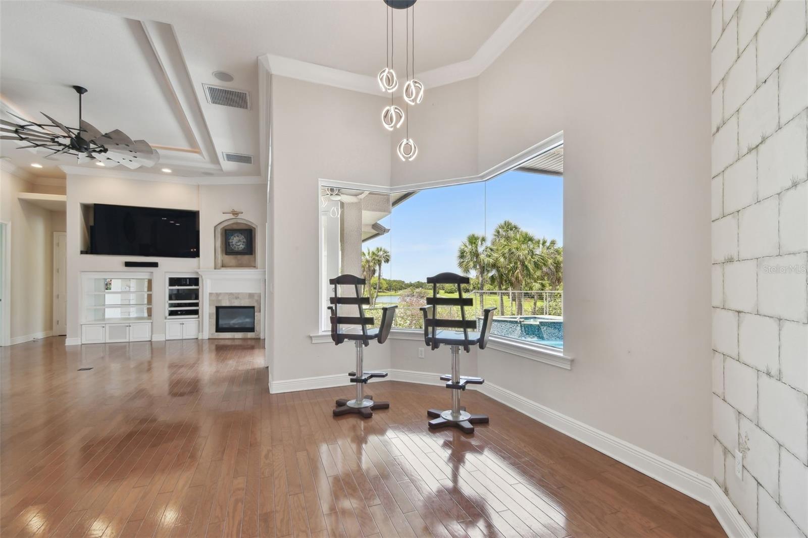 Breakfast area adjacent to kitchen and family room with views of the swimming pool and golf course.