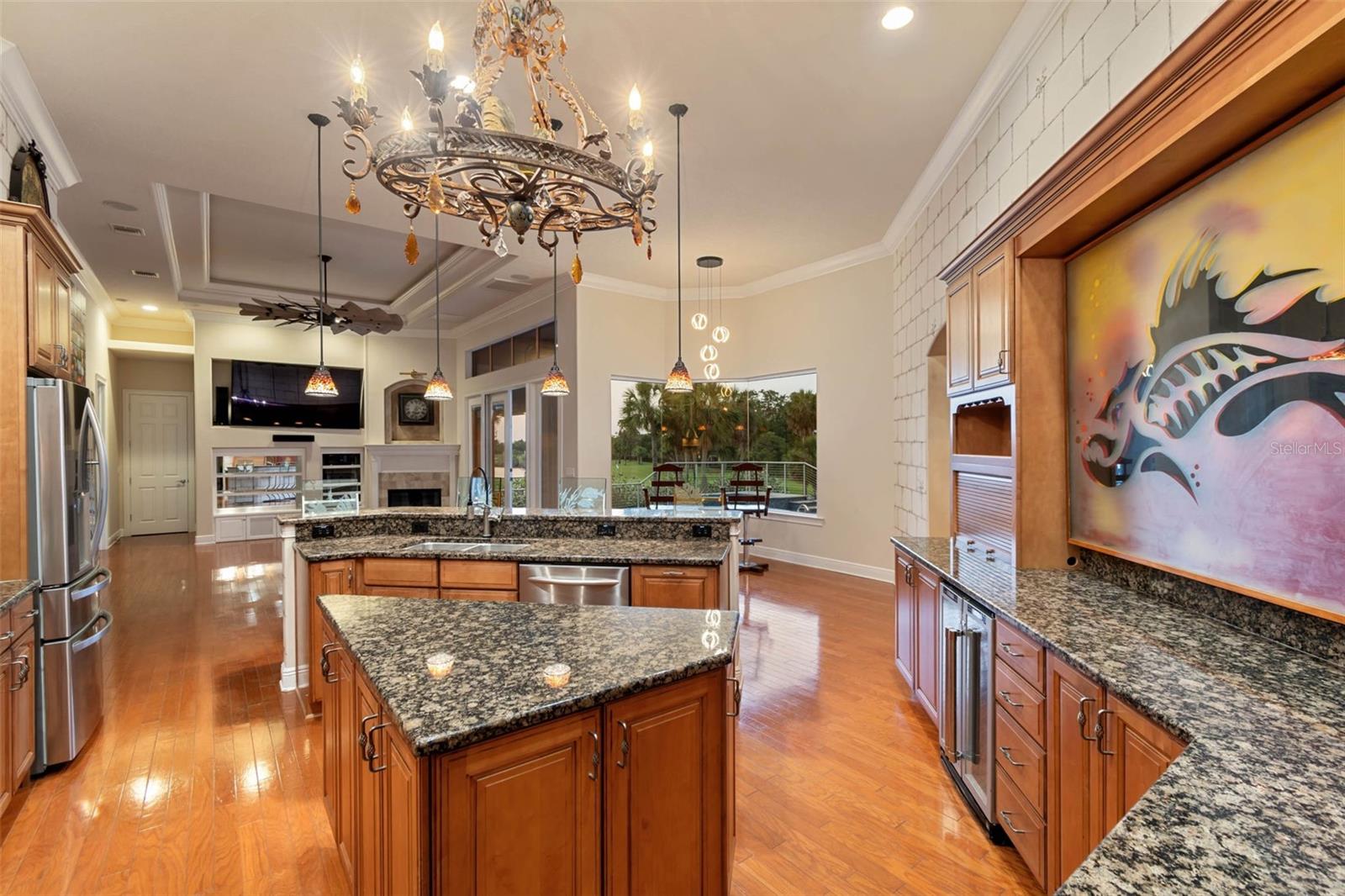 Sparkling family room and kitchen as sunset begins.  Notice the artwork.