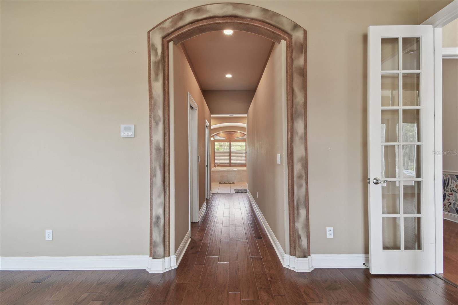Hallway entry to the primary bath and closet area.