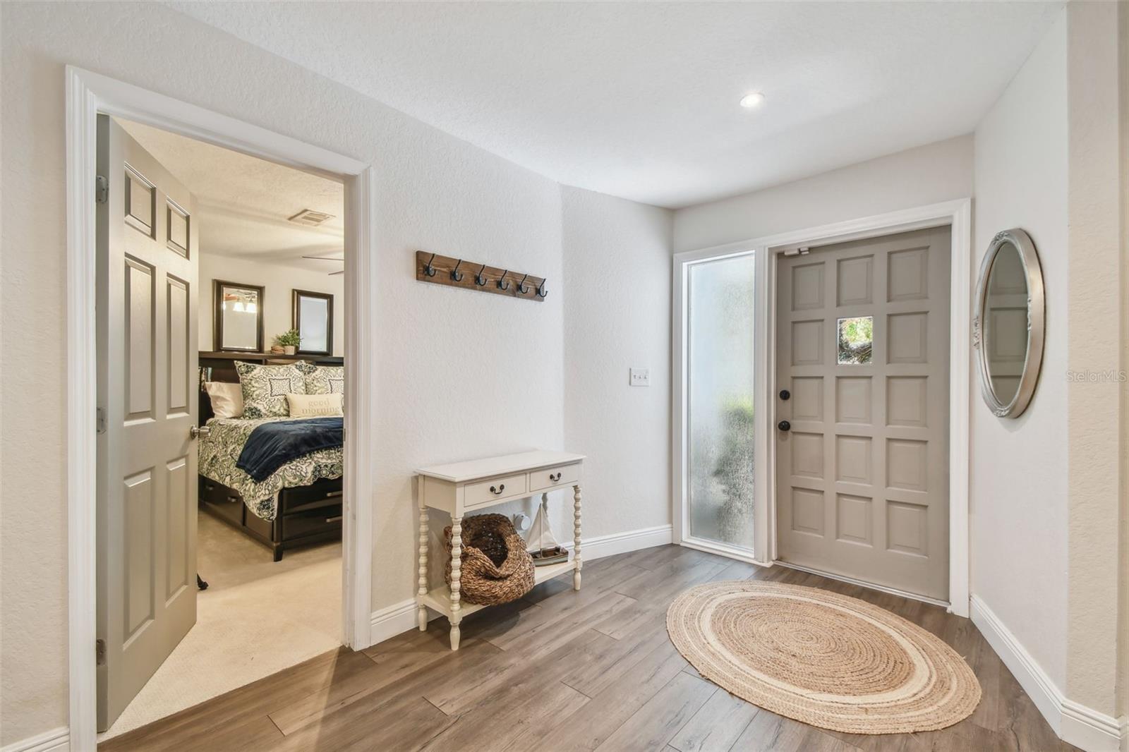 Spacious entryway with custom lighting and custom painted doors.