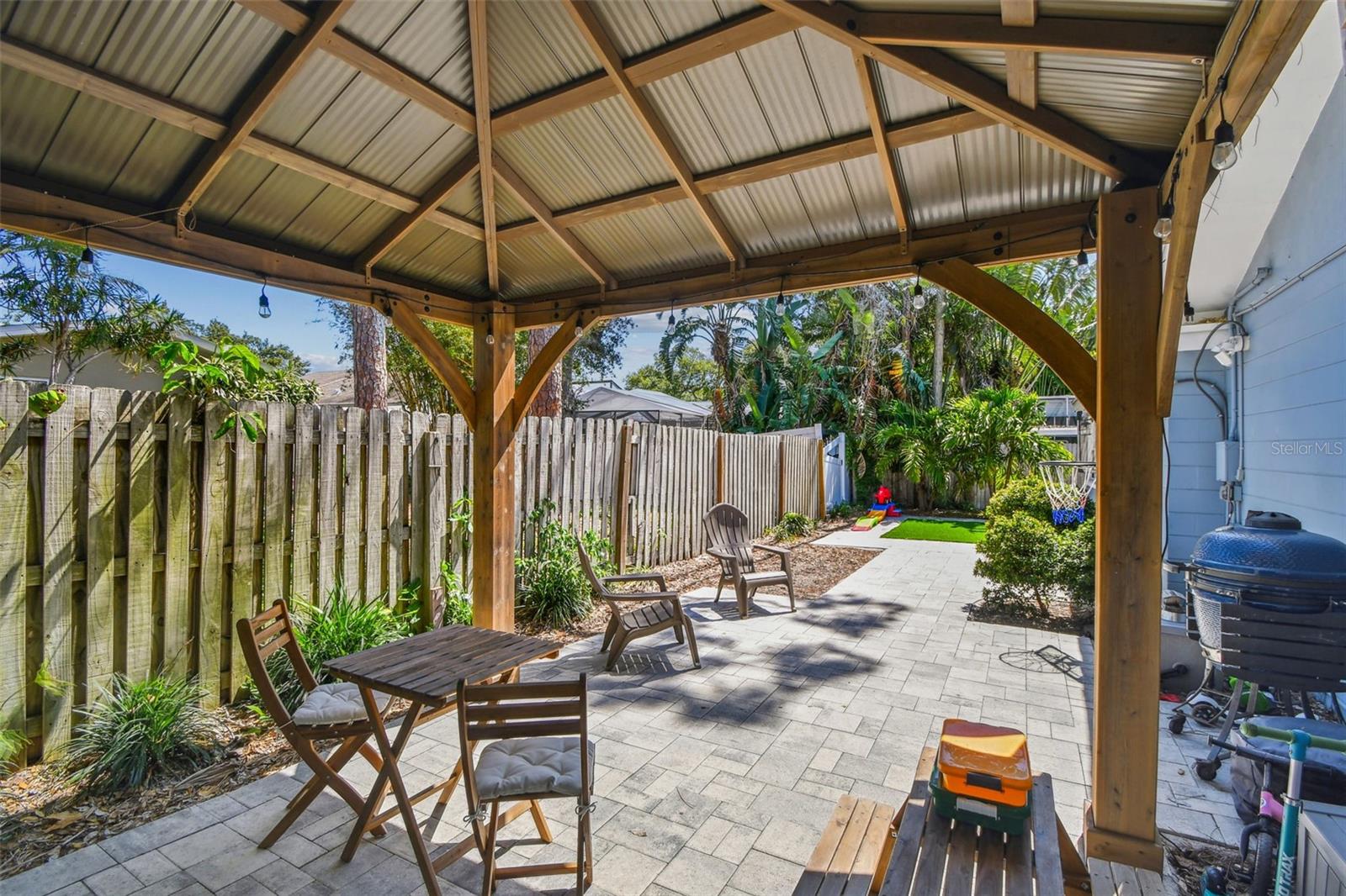 Fenced yard with Pergola - artificial turf and paved area