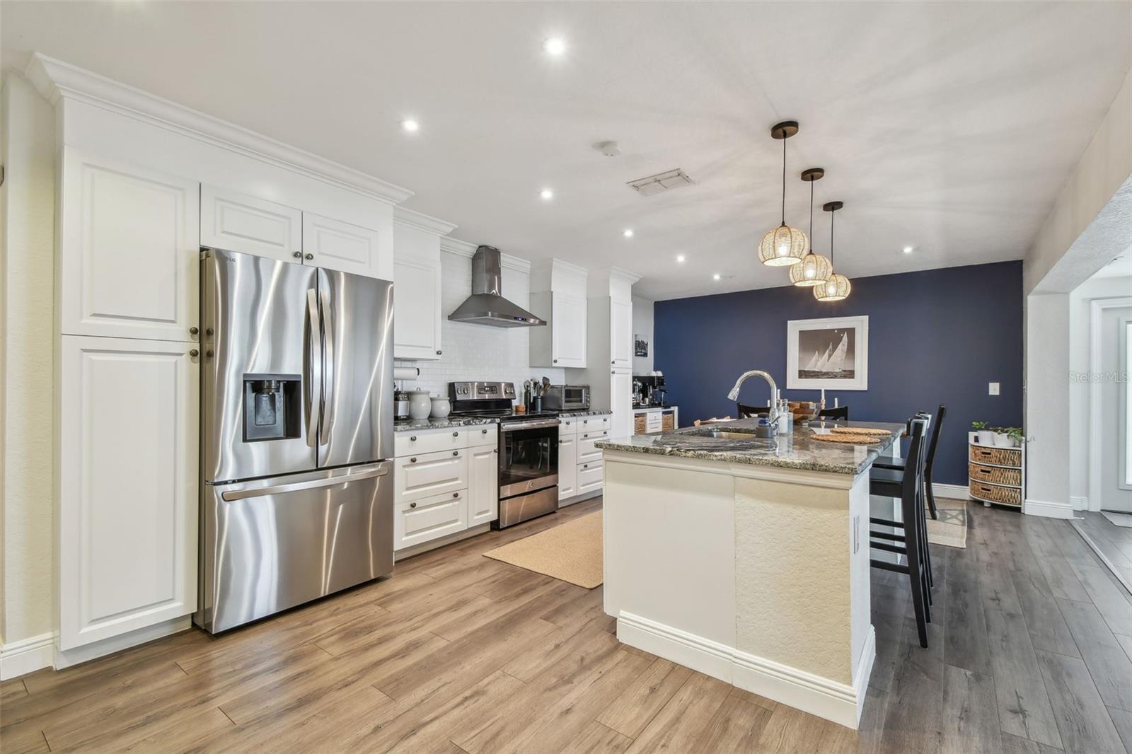 Updated kitchen with stainless steel appliances, luxury laminate flooring, granite tops and tile backsplash.