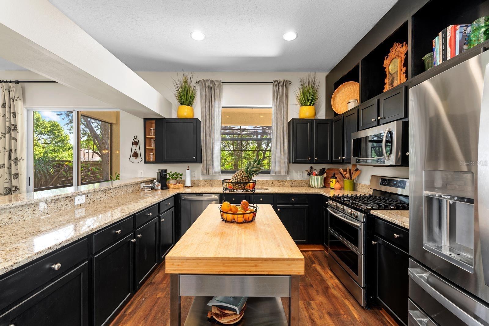 What a beautiful, updated and elegant kitchen!  The butcher block island with a stainless base will stay with the home.