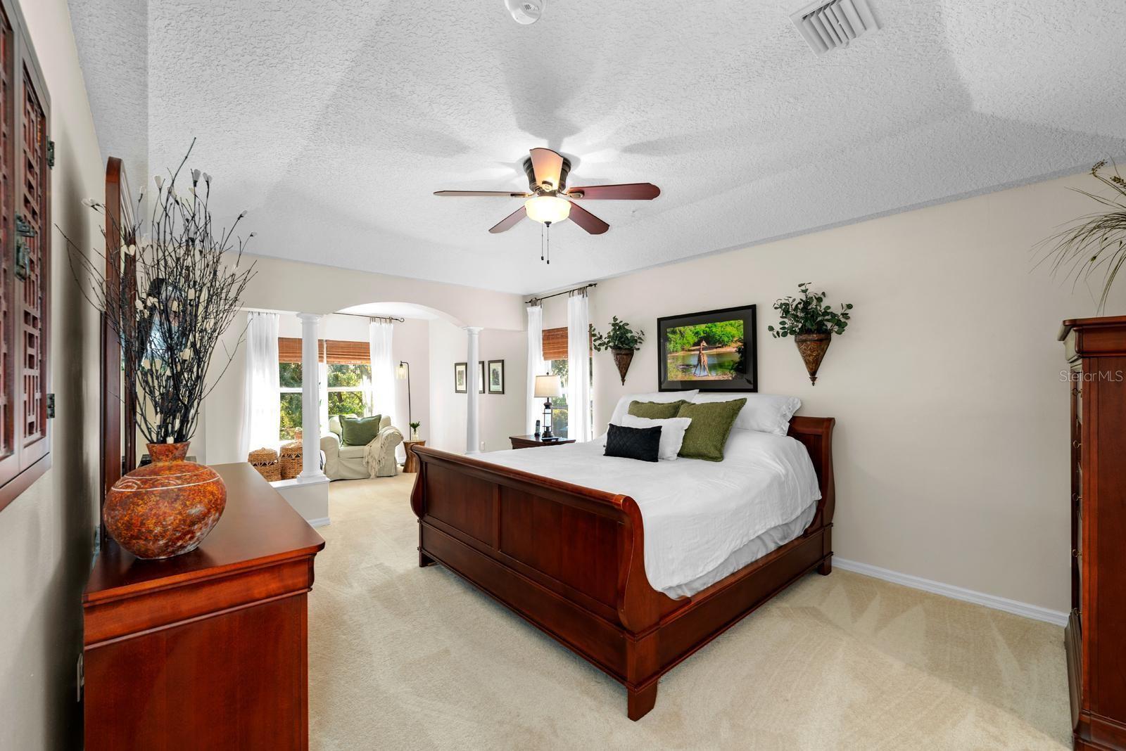 The primary suite is an escape to relaxation!  It features fresh newer carpet, a tray ceiling, a separate sitting area with natural light flooding in, a lighted ceiling fan, TWO walk-in closets, and an UPDATED ENSUITE!