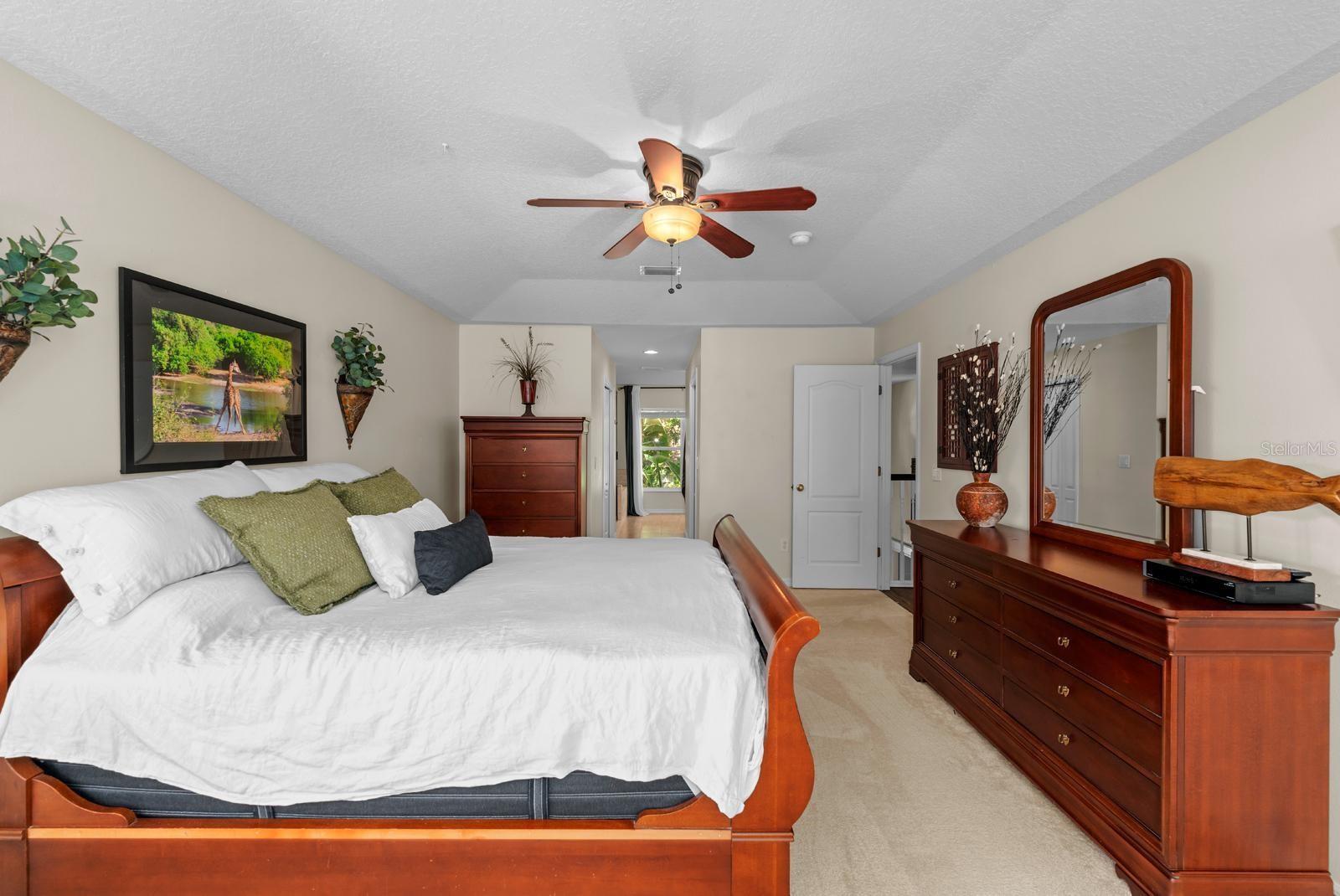 The primary suite is an escape to relaxation!  It features fresh newer carpet, a tray ceiling, a separate sitting area with natural light flooding in, a lighted ceiling fan, TWO walk-in closets, and an UPDATED ENSUITE!