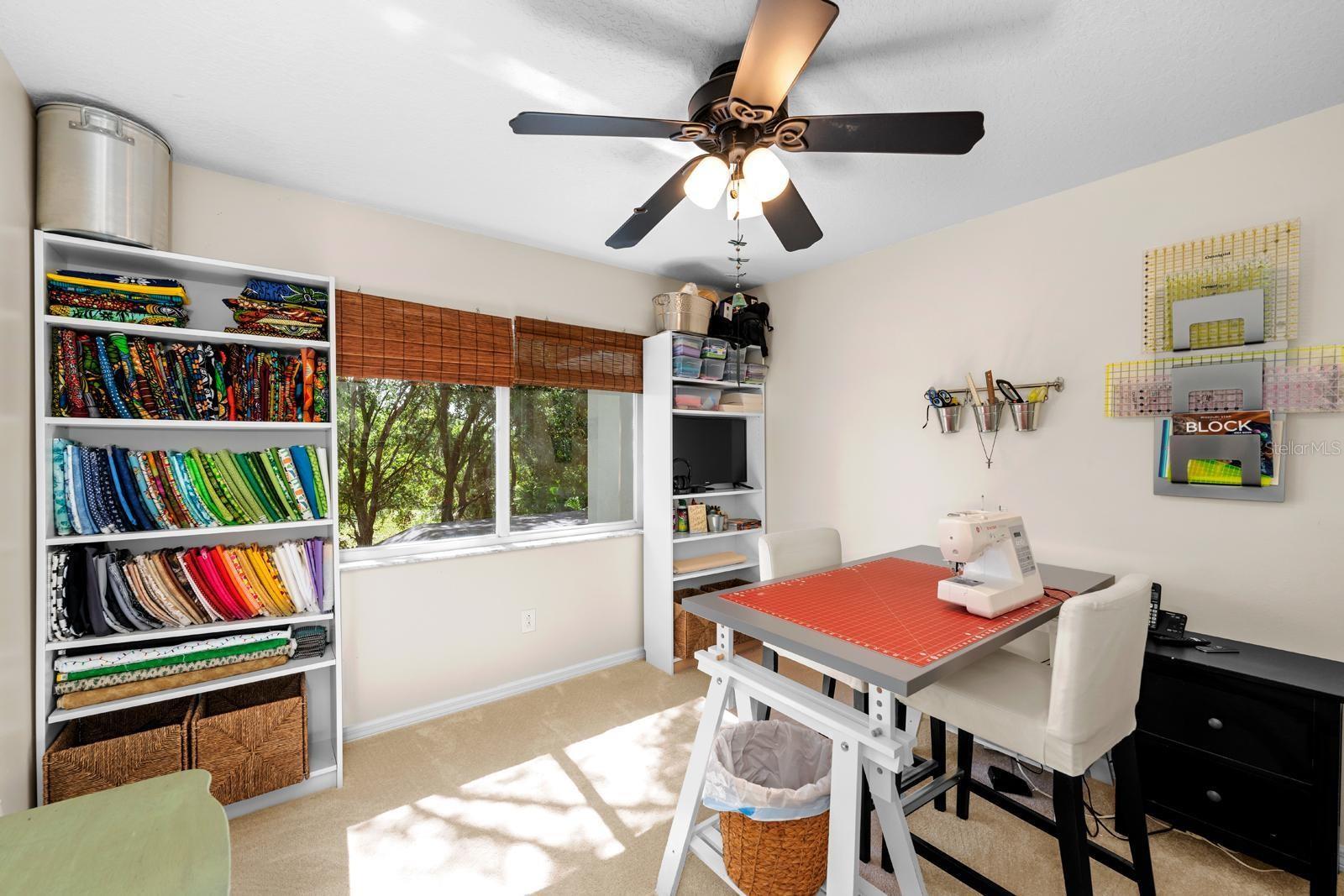 Another secondary bedroom.....also features fresh newer carpet, a lighted ceiling fan, and an oversized closet. It's currently being used as a craft room.