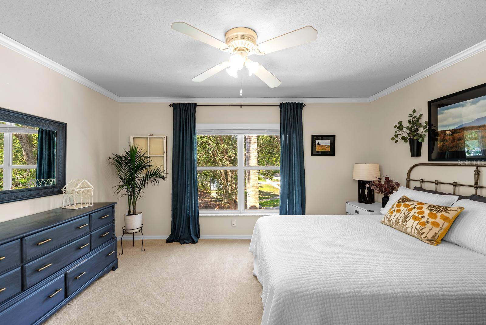 The 3rd secondary bedroom features fresh newer carpet, a lighted ceiling fan, an oversized closet, and crown molding.