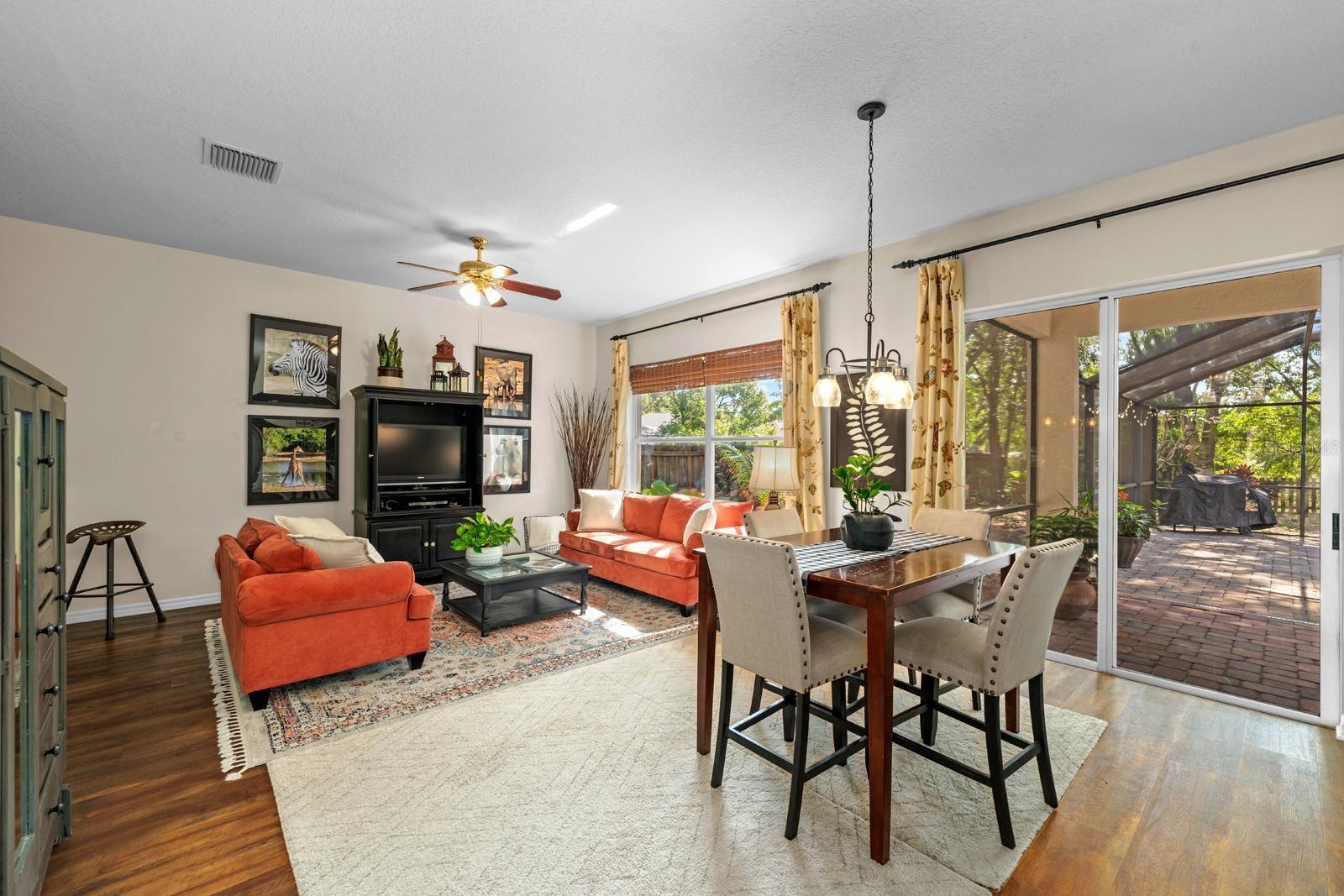 The spacious Family Room/Living Room allows in lots of natural light, features a DRY BAR in the left corner, and has a large under-the-stairs closet over there on the left too.