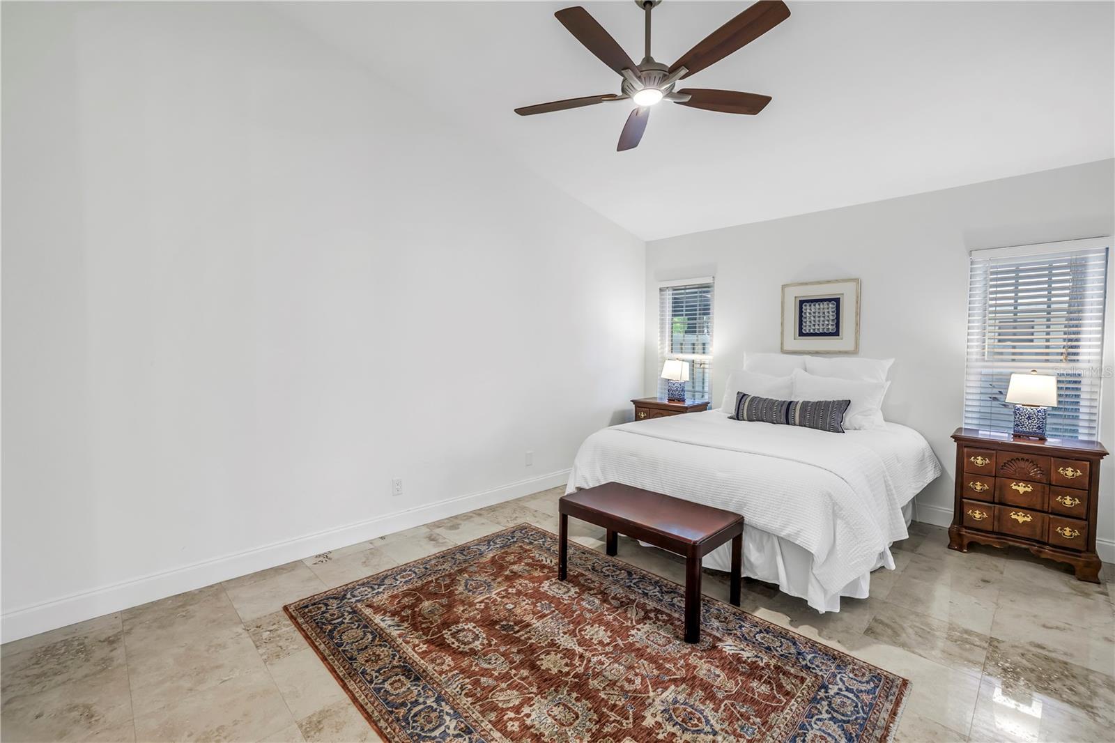 Vaulted Ceilings in Primary Bedroom with view to the patio