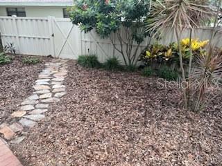 Stepping stones to back fence exit.  6-Ft Vinyl Privacy Fence