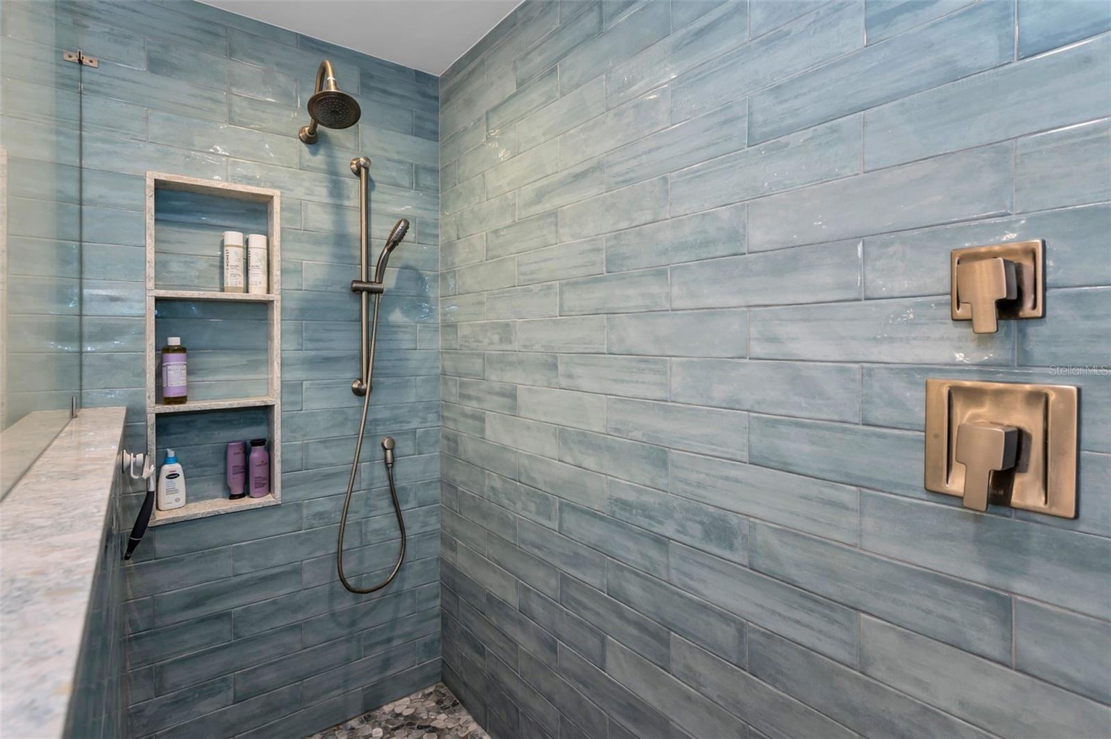 Primary walk-in shower with storage insets