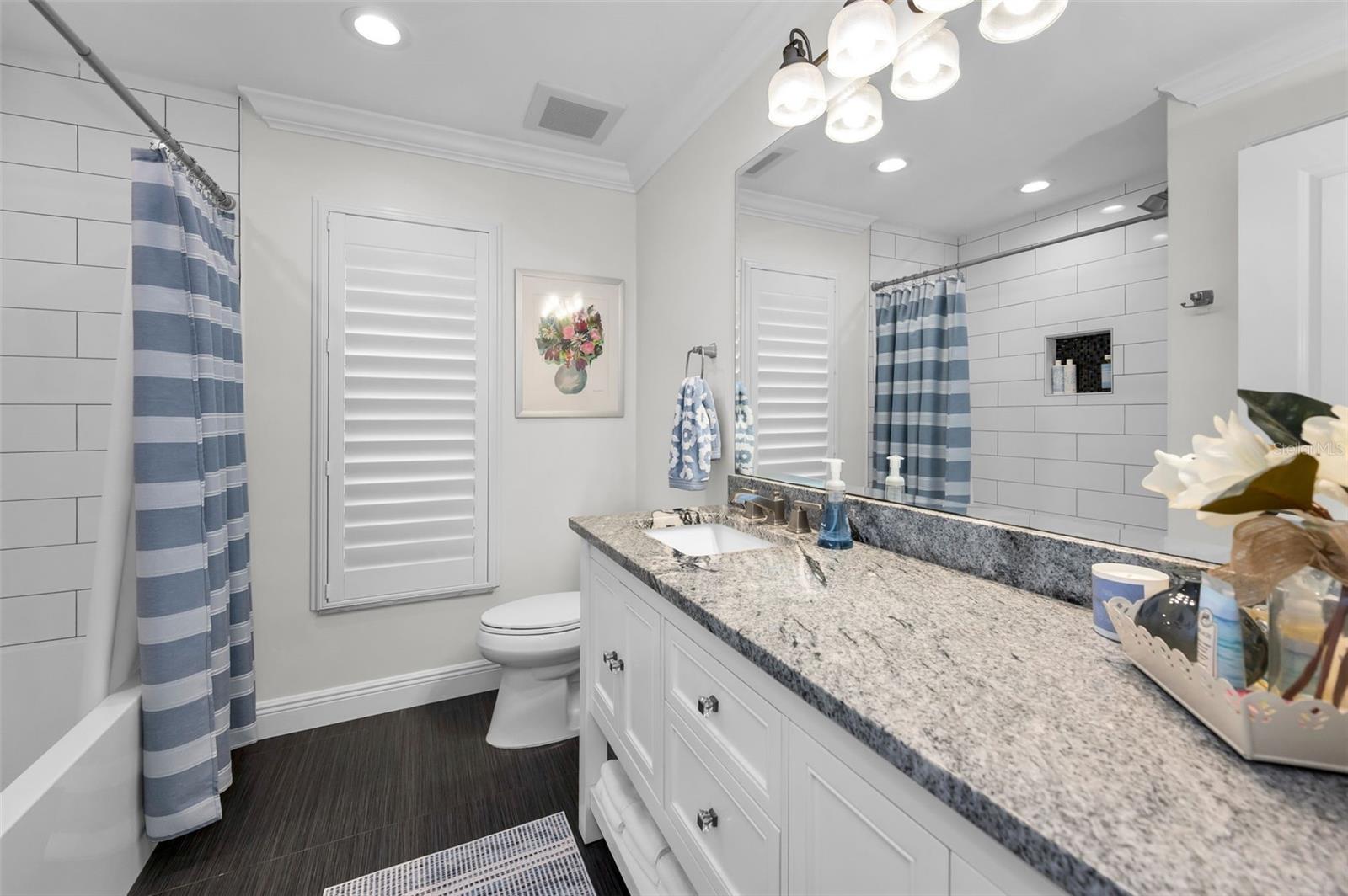 Guest bath located off hall between two bedrooms