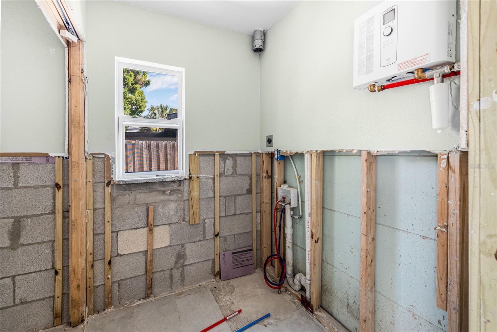 Utility Room Tankless hot water heater newer