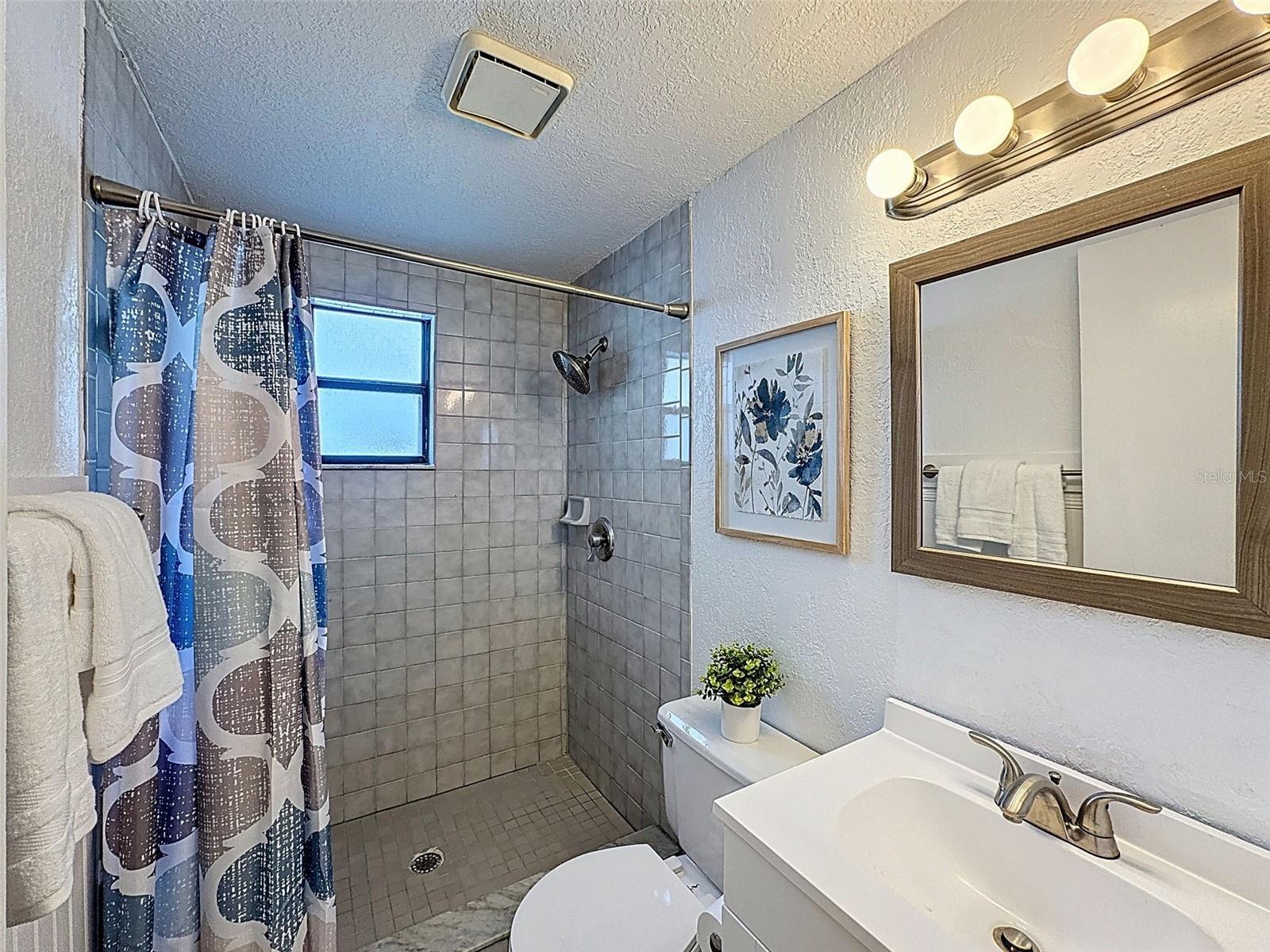 THIS BATHROOM IS LOCATED BY THE GARAGE HALLWAY