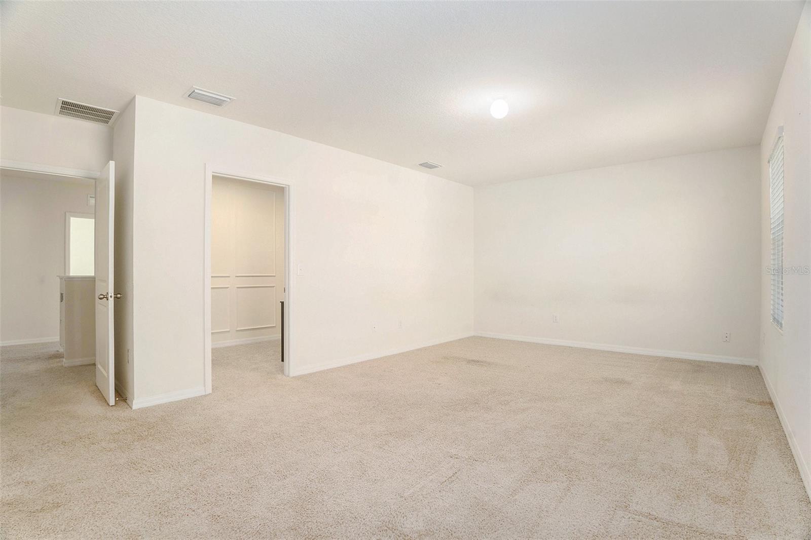 Primary bedroom view of entry and closet