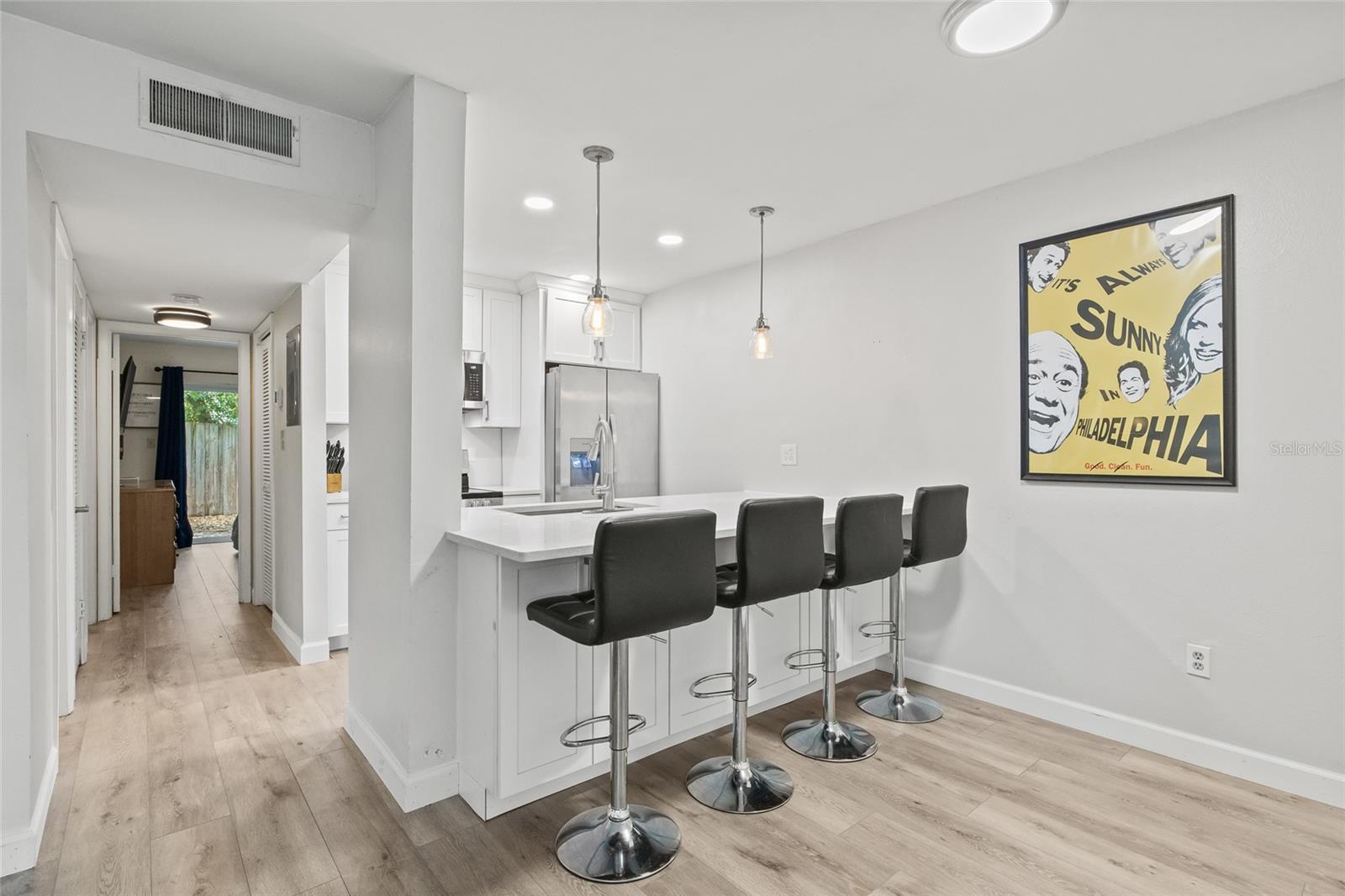 The kitchen has been opened up by removing a wall, creating a more spacious and open-concept feel that flows seamlessly into the living area.