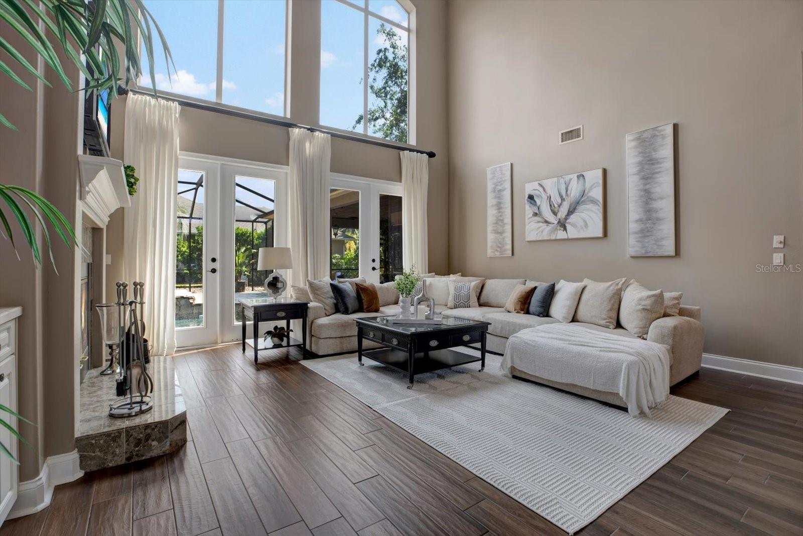 Large formal living area with 2 sets of french doors leading to covered pool / lanai.