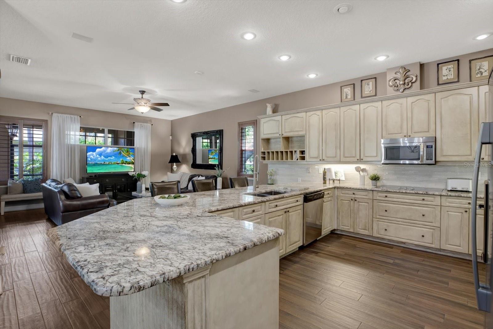 Ample granite covered counters and wood cabinets.