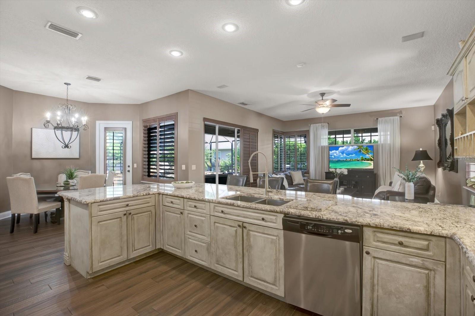 Open concept leads to family room, breakfast nook and lanai/pool.