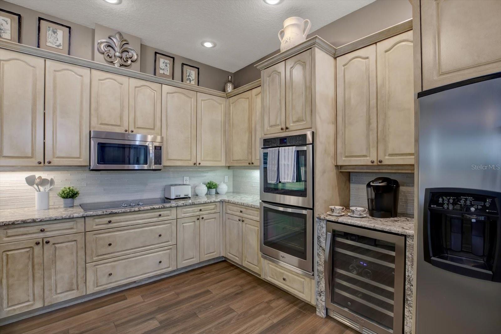 Chef's dream kitchen with stainless steel appliances including double ovens, wine cooler and NEW refrigerator.