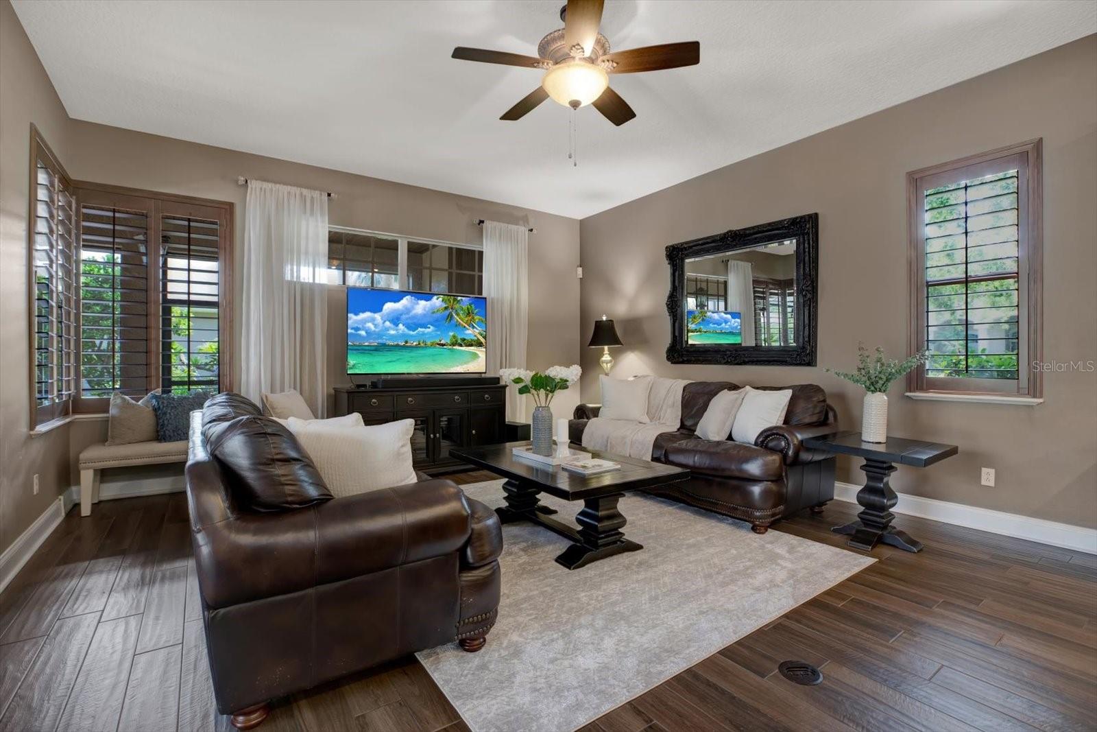 Family room with sliding pocket doors to lanai and plantation shutters.
