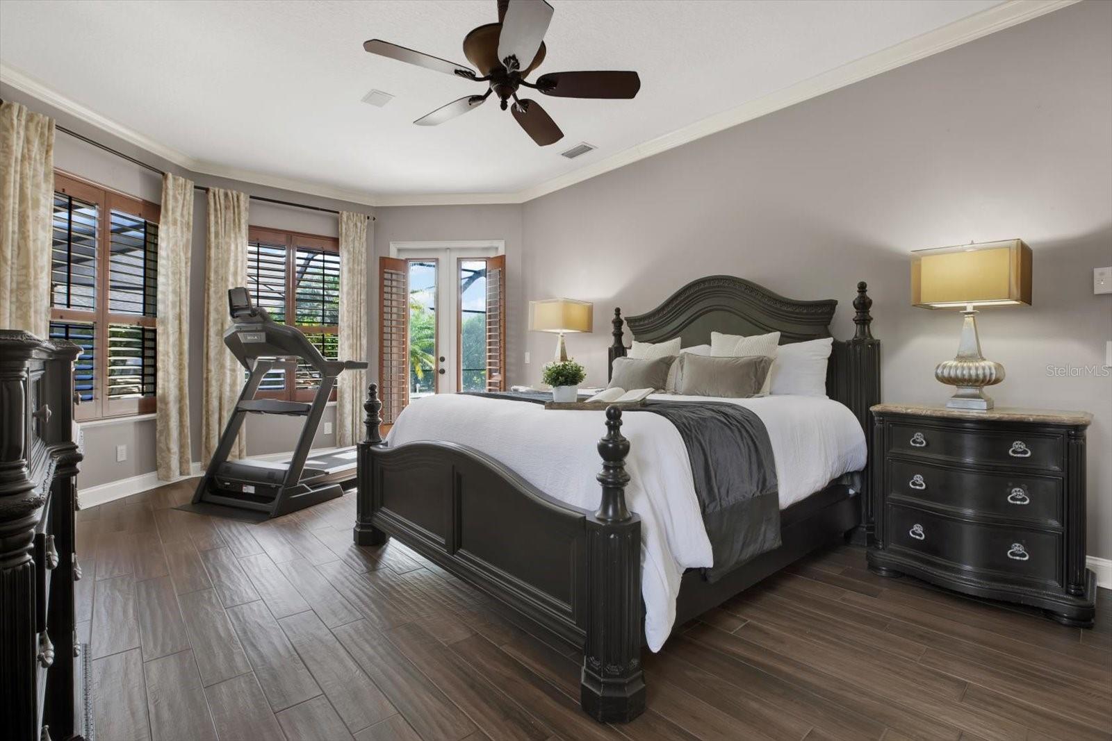 Large primary suite with double doors leading to pool.