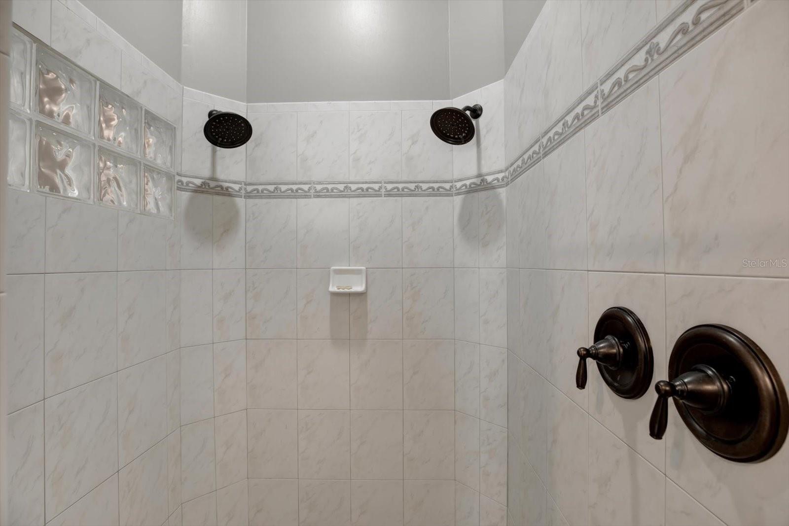 Primary ensuite has a separate walk in shower with dual shower heads and separate enclosed water closet.