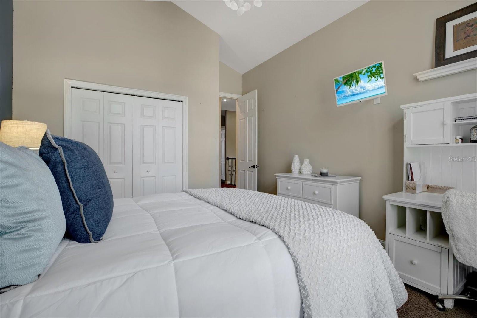 Bedroom 2 with double doors and built in closet shelving.