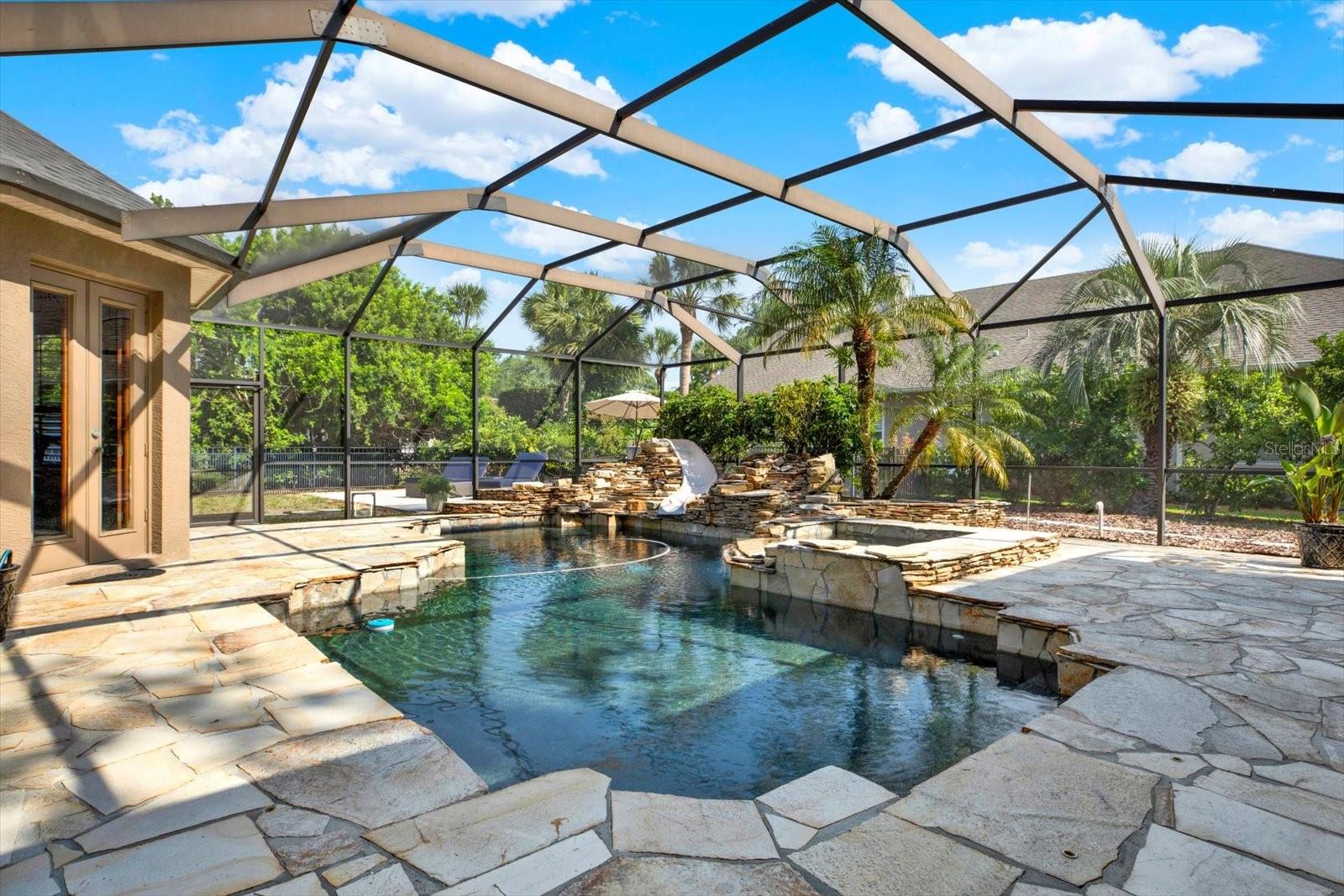 Beautiful screened pool, with slide and waterfall jacuzzi.  Cholorine pool with new pool pump.