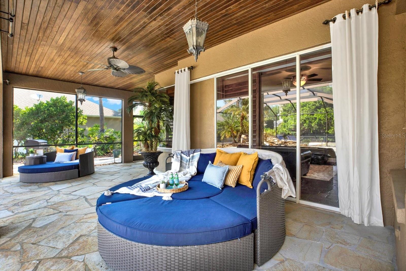 Wrap around lanai  leads to wet bar, storage closet and paved grill area.