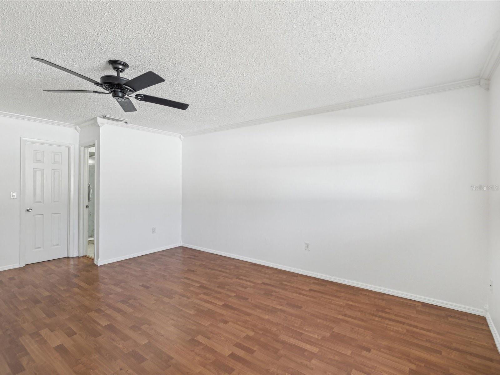 Primary bedroom showing walk in closet door and ensuite
