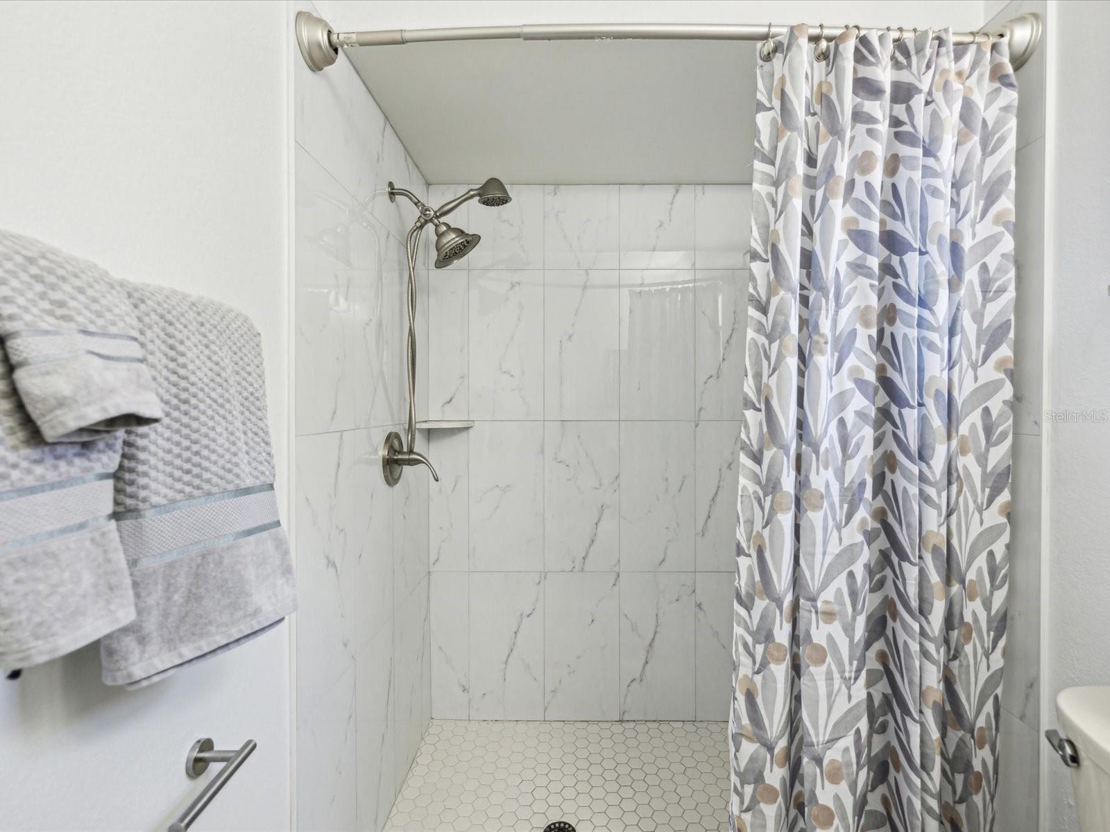 Walk in shower in the primary bedroom