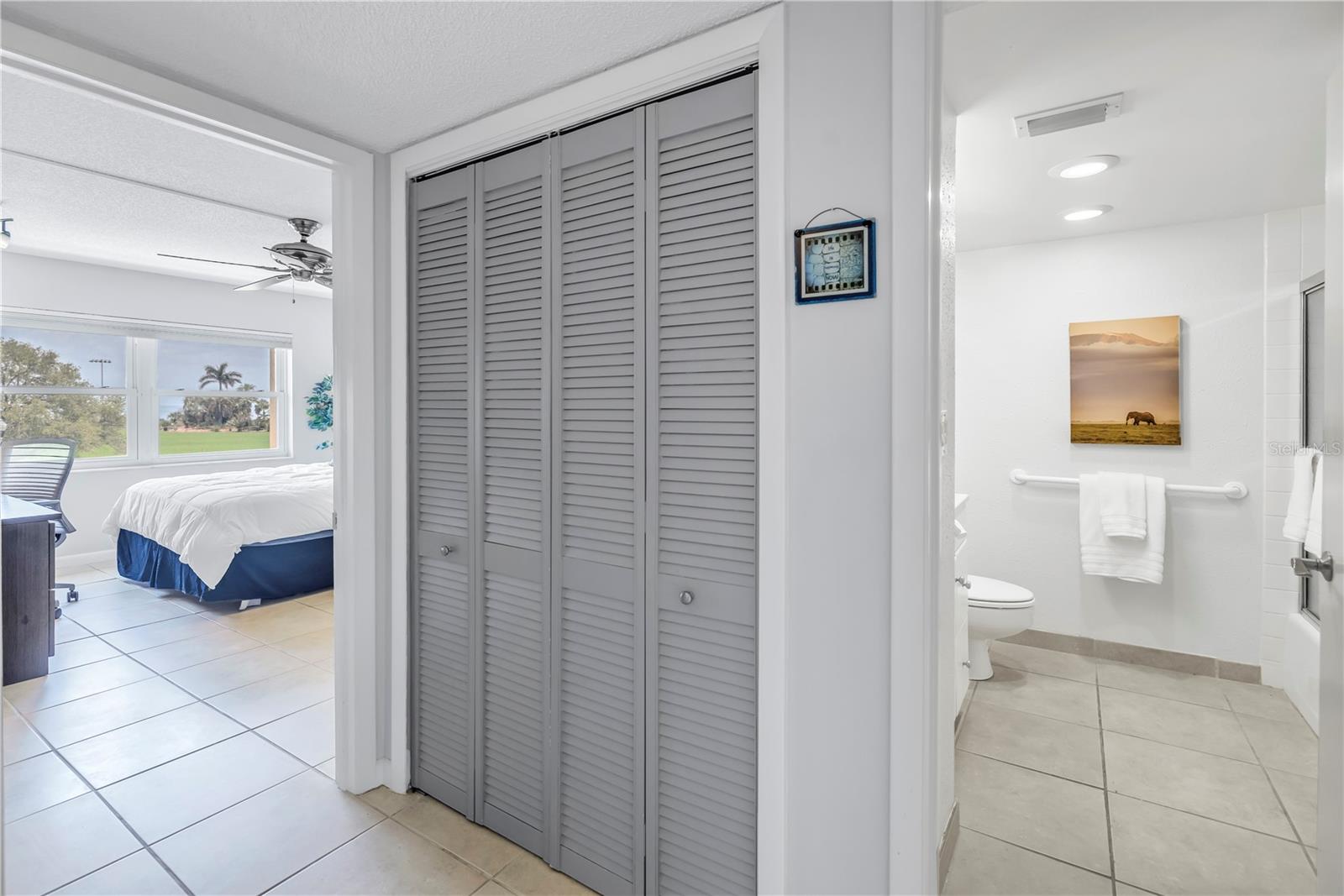 Private hallway with storage for the guest suite and access to the guest bath