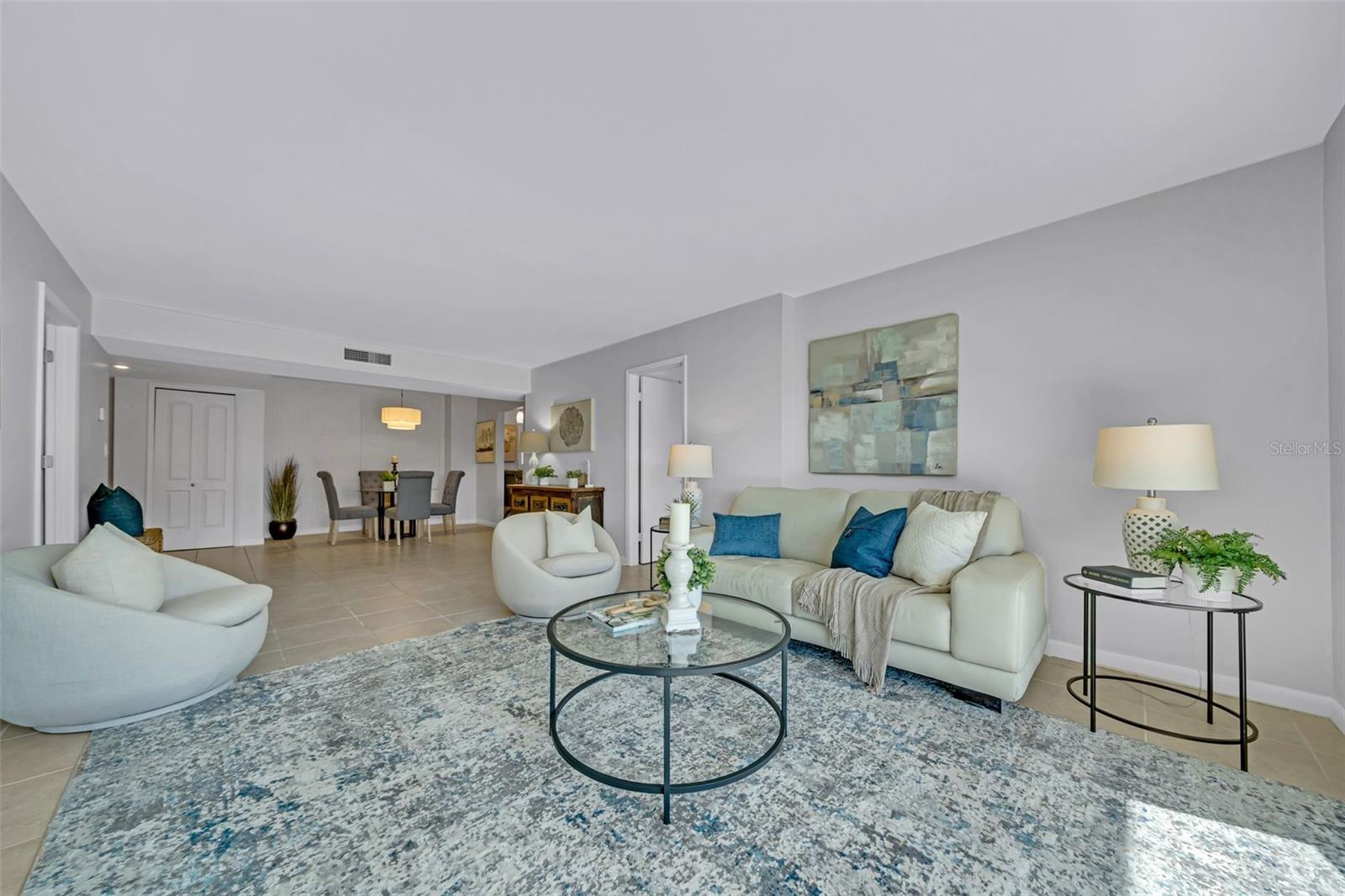 Spacious living area is open to the dining and separates the two bedroom suites