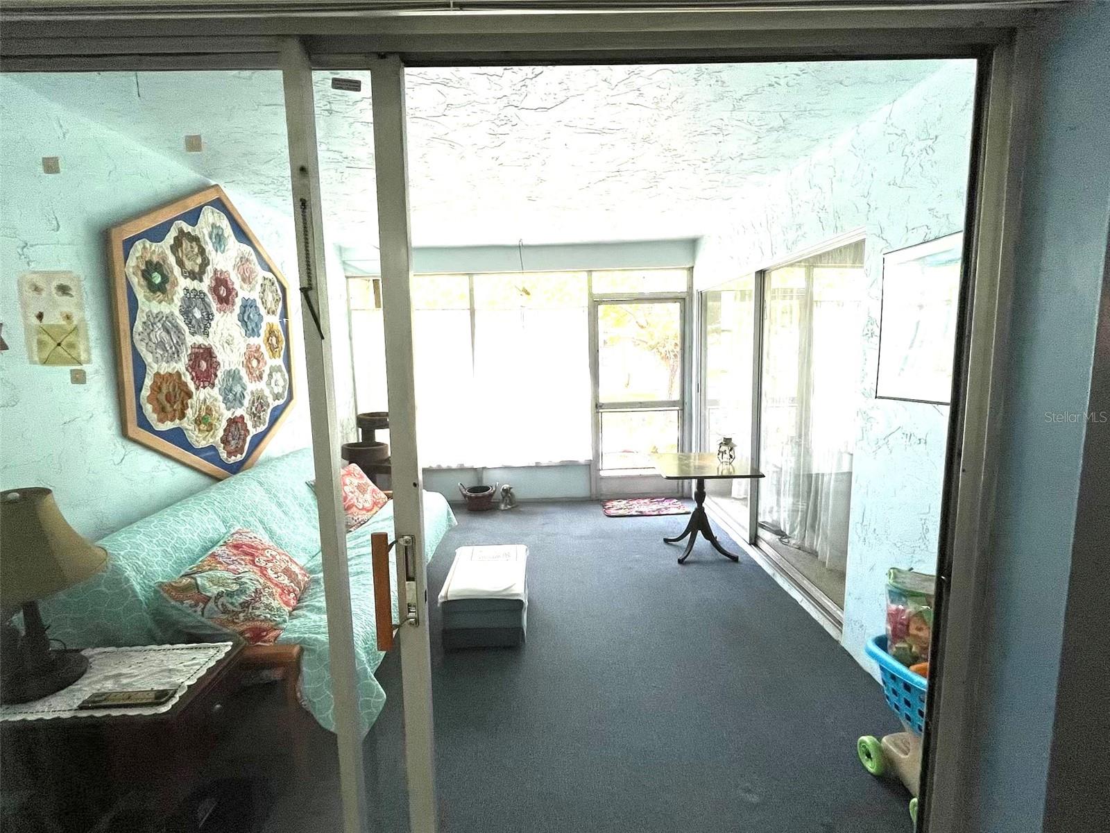 RELAXING SCREENED PORCH AT REAR OF CONDO FACING GREEN SPACE