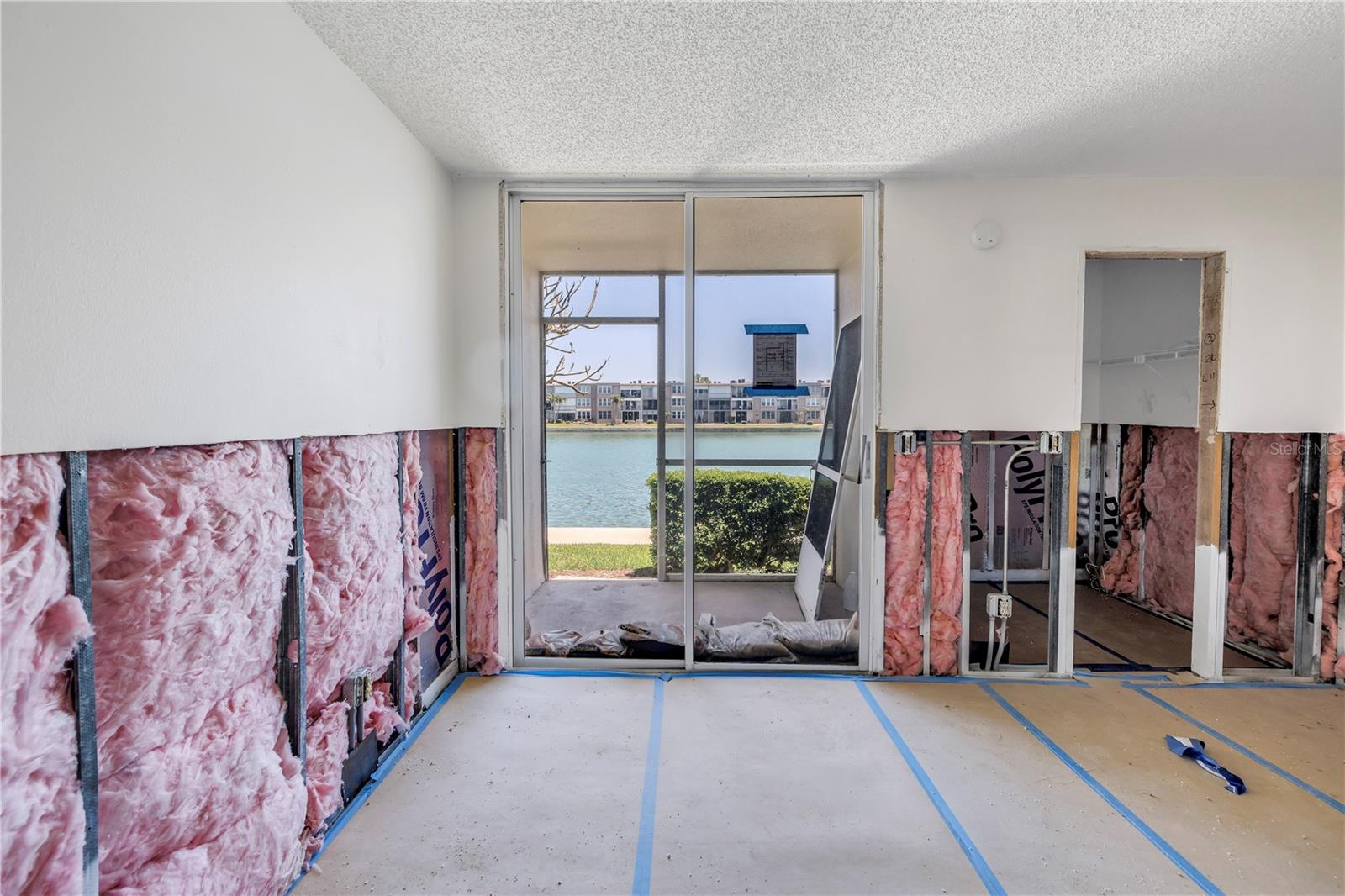 Bedroom with walk-in closet & sliding doors to the screen enclosed porch