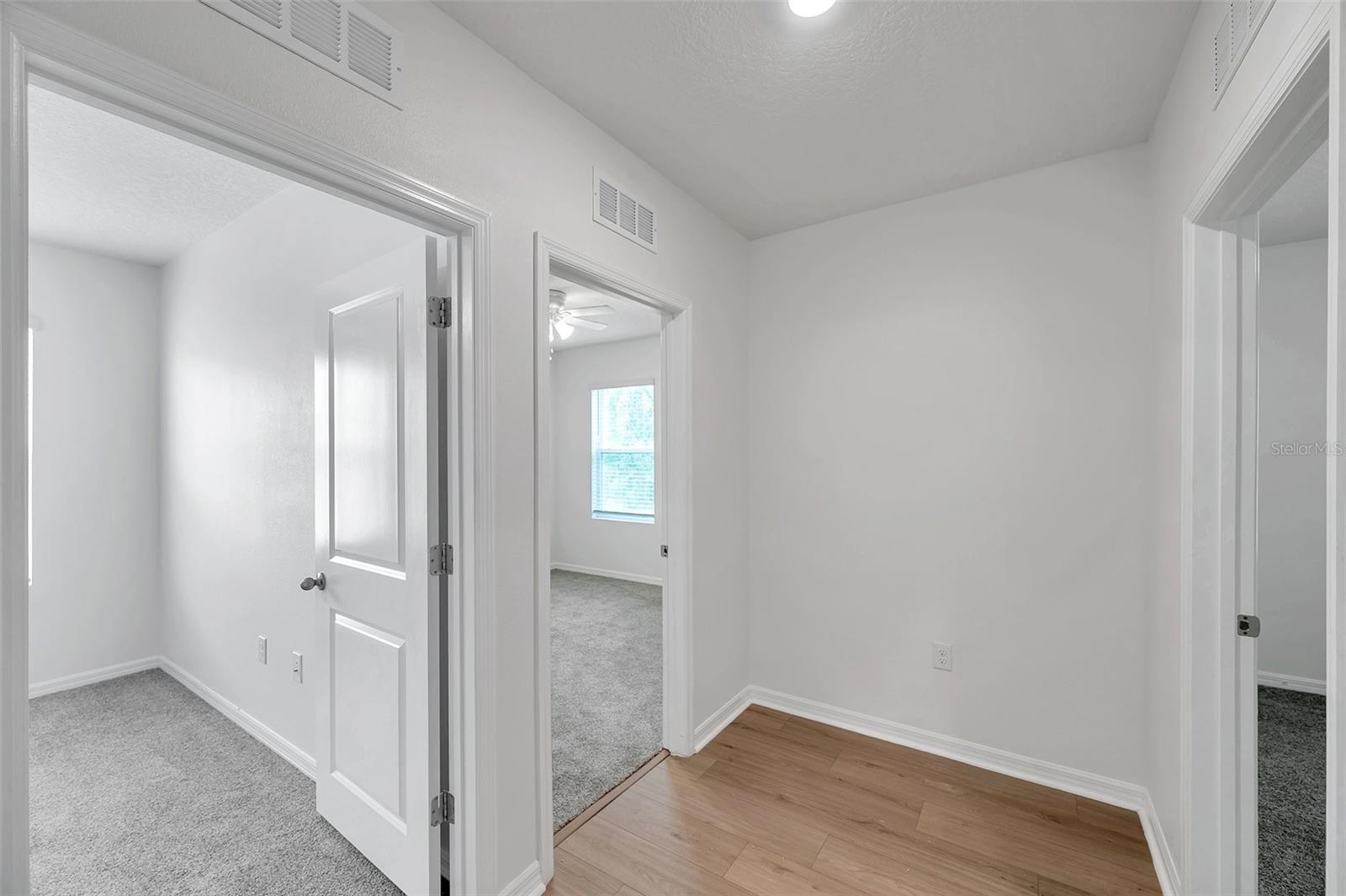 hallway to the 3 additional upstairs bedrooms