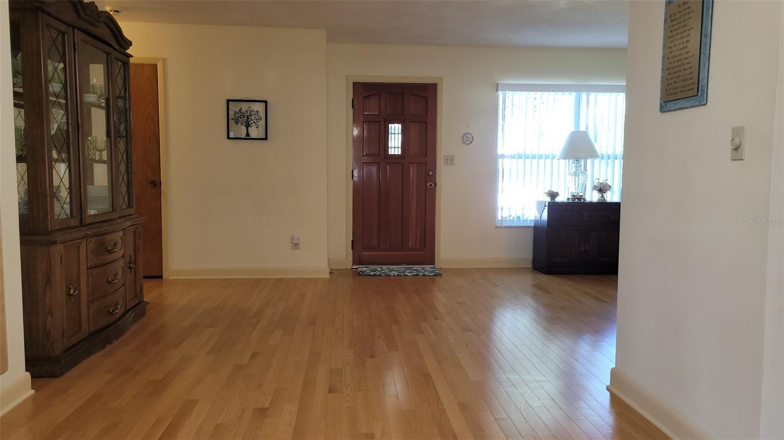 The beautiful laminate floors throughout most of the home are actually "sandable" should repairs be needed. The area shown was being used as the dining room and is just off the kitchen.