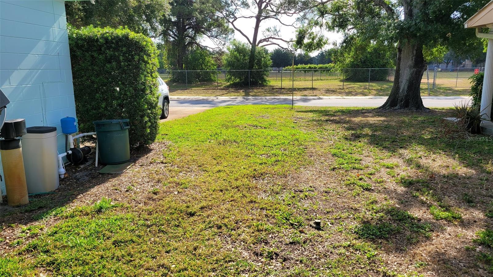 Garage side of the home toward the street. Notice there are no homes across the street, this is a field from a local school. There is a public park accessible to neighbors after school hours, that is up the street to the right.