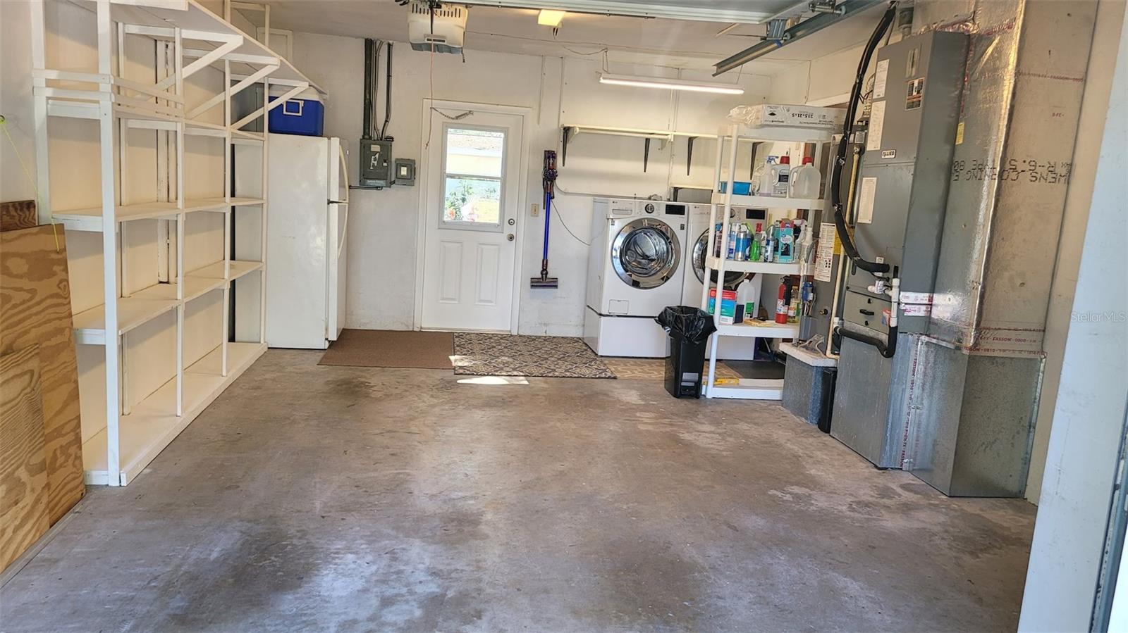 The 15X20 garage houses the laundry area, spare refrigerator, Gas water heater, HVAC, extra shelving and wood panels for the windows, leaving space for a car!!