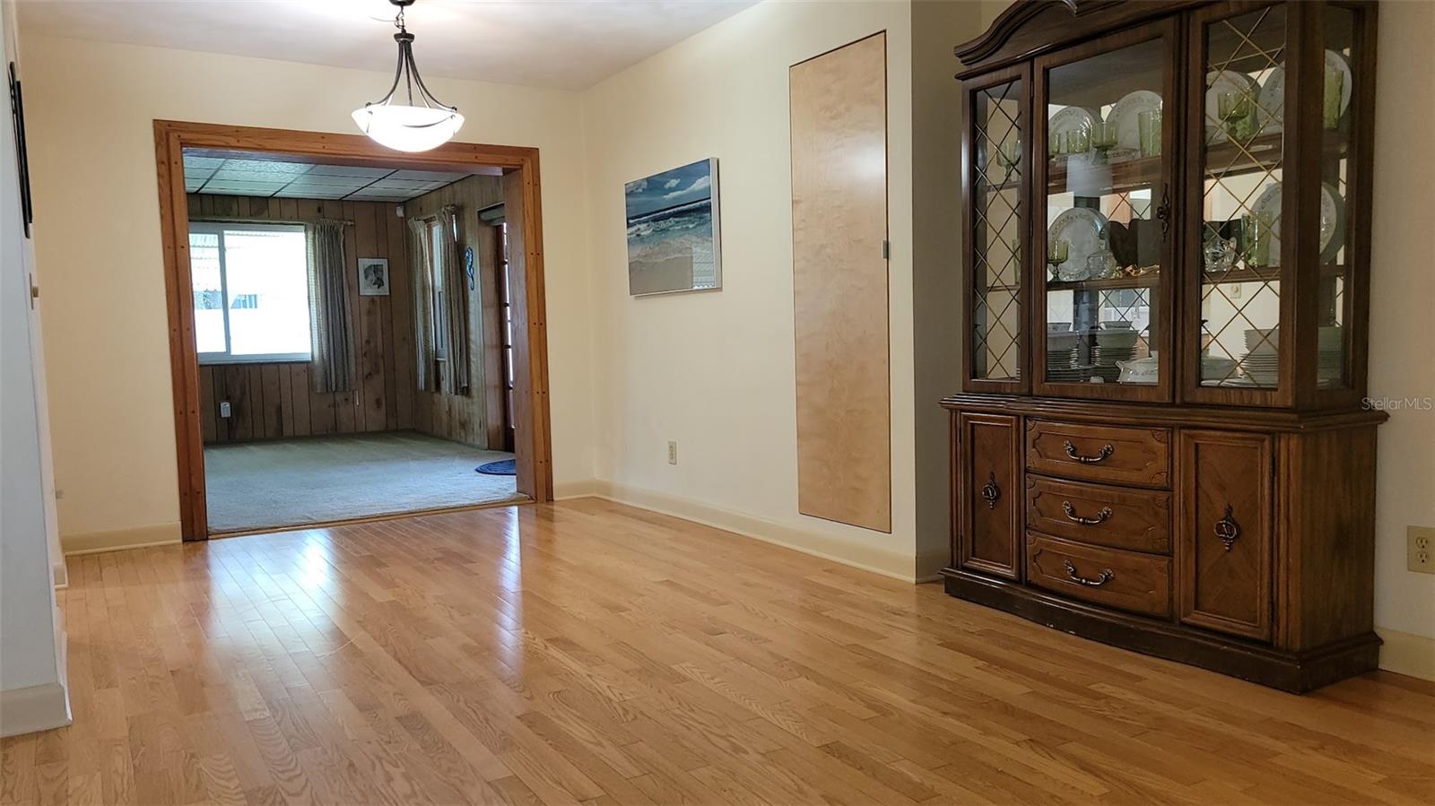 View from the front door. Notice the door in the dining area. This is additional storage with shelves. Could hold pantry items, games, or other treasures.