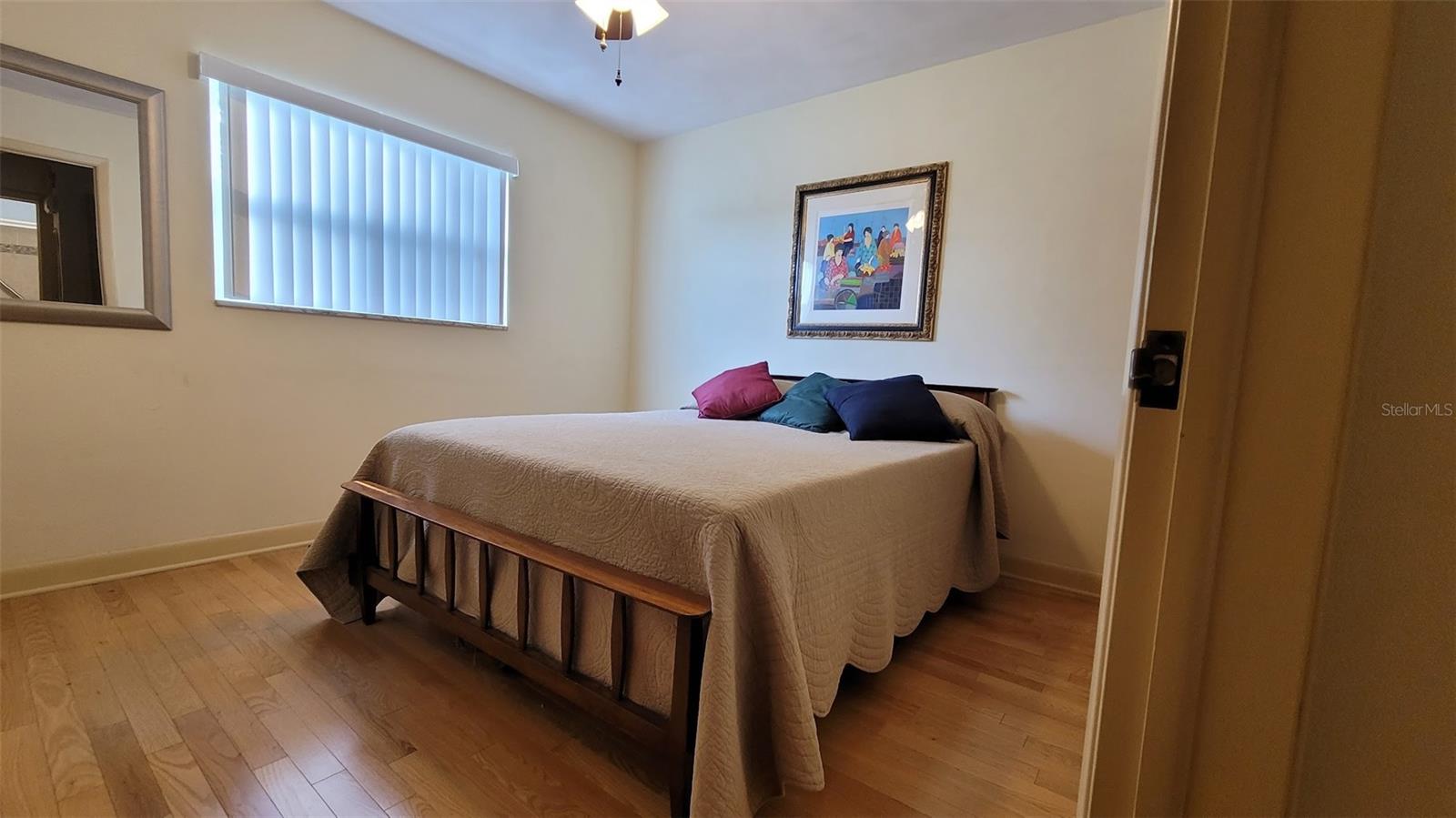 The Primary bedroom is 10X13 and has a built-in closet. It sits in the back of the home. The window you see looks out to the screen in back porch.